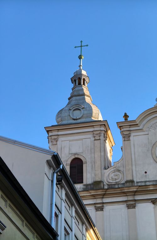 Free Stunning architectural detail of a historic church tower in Piotrków Trybunalski, Poland. Stock Photo