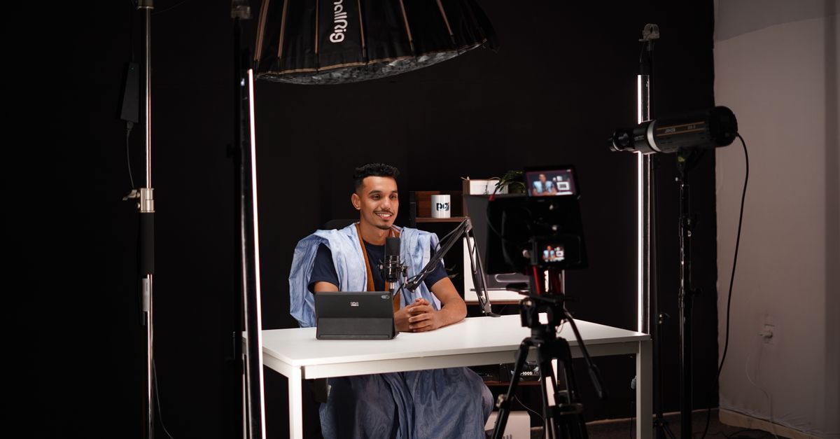 A diverse group of young creators filming a web series with professional lighting and cameras in a modern studio