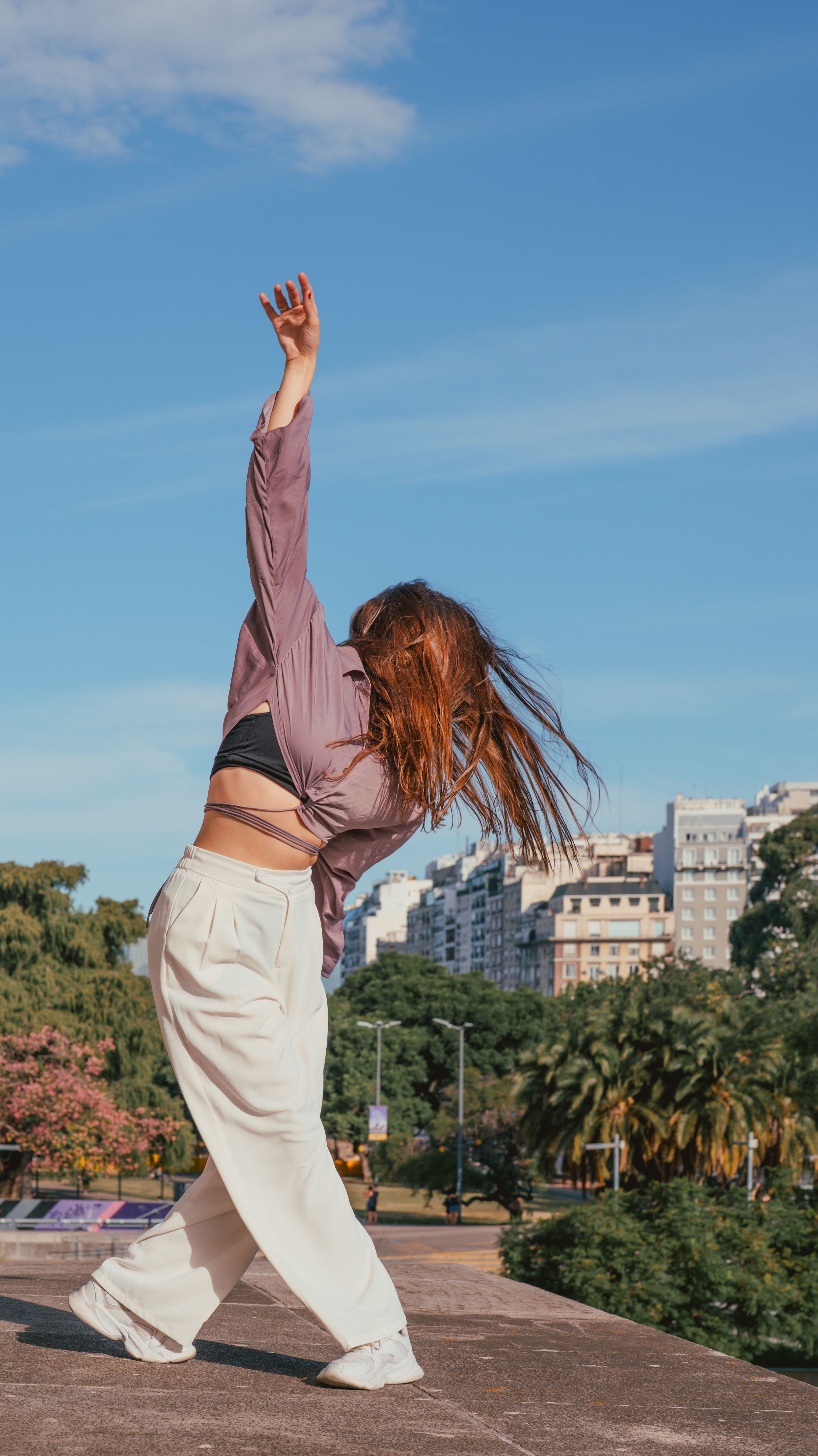Young Woman Dancing Outdoors in Urban Park · Free Stock Photo