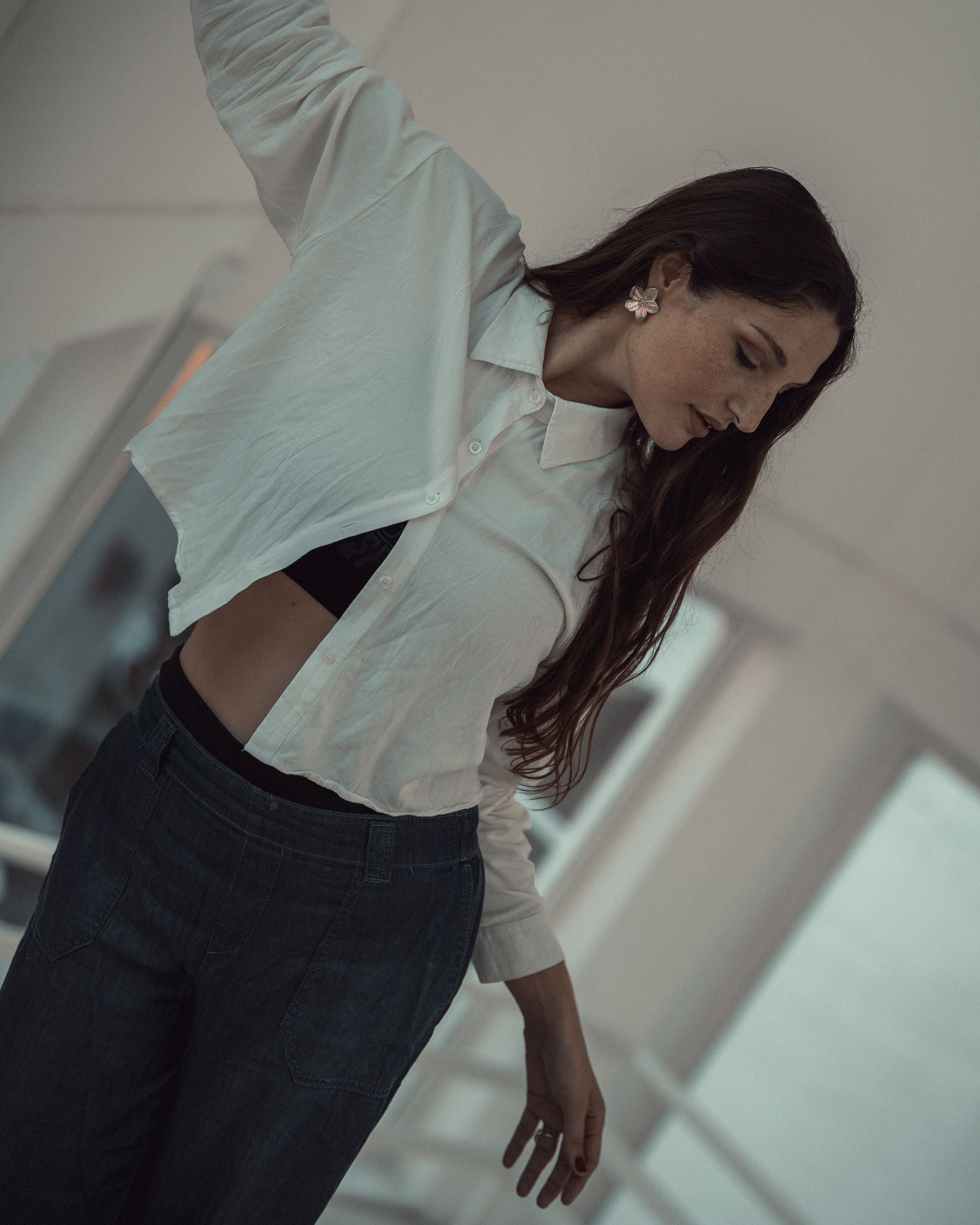 Contemplative Woman in Modern Minimalist Setting · Free Stock Photo