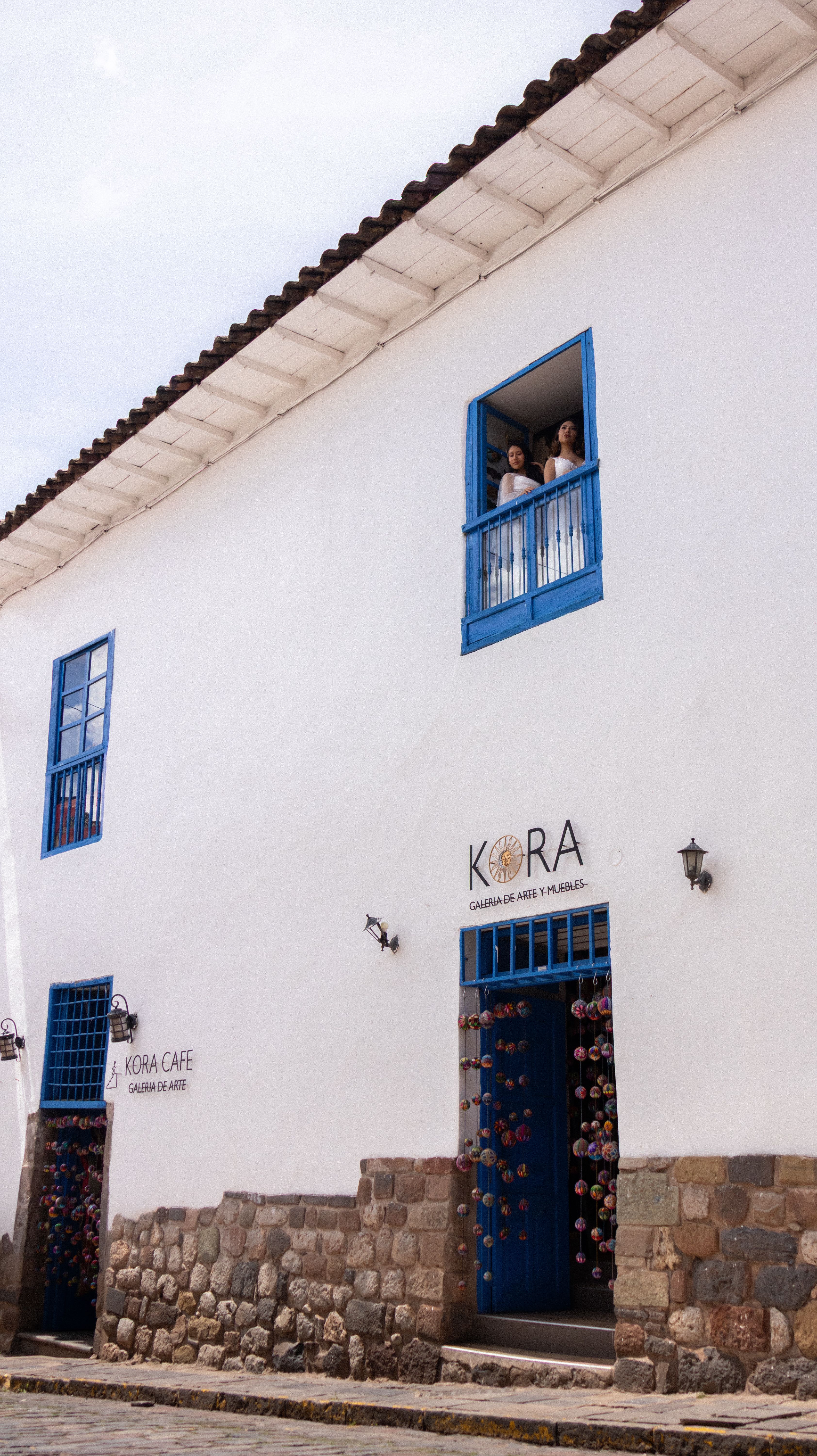 Colonial Architecture Cafe Exterior with Blue Doors · Free Stock Photo
