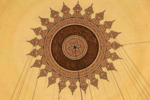 Beautiful geometric ceiling design with Islamic art patterns showcasing symmetry and detail.