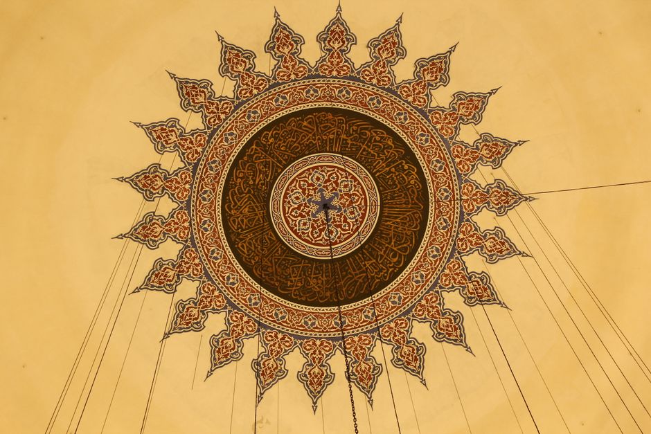 Beautiful geometric ceiling design with Islamic art patterns showcasing symmetry and detail.