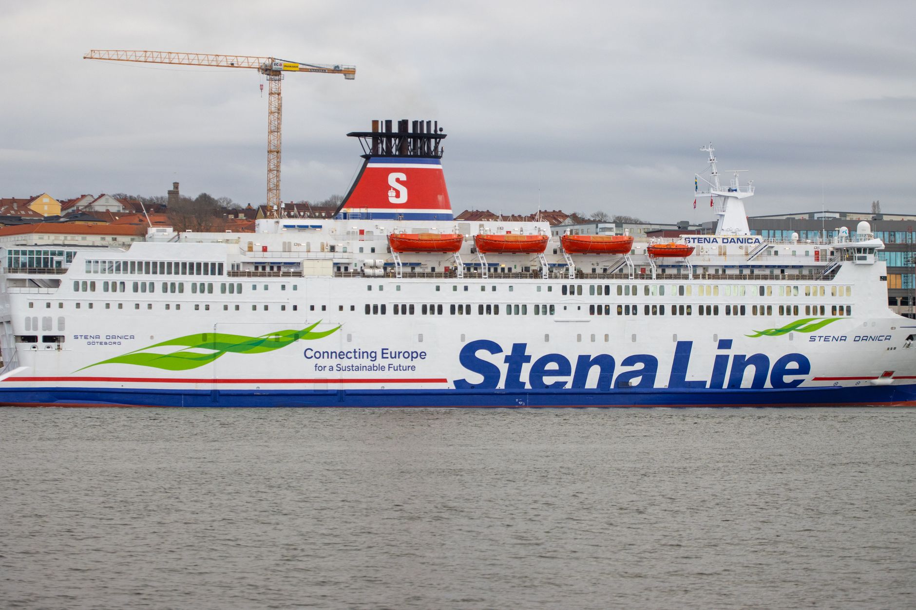 Stena Line ferry docking in Gothenburg, Sweden with a crane and cityscape in the background.