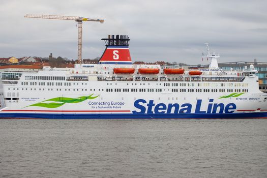 Stena Line ferry docking in Gothenburg, Sweden with a crane and cityscape in the background.