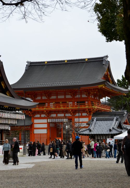 Free Crowds gather at the historic Fushimi Inari Shrine in Kyoto, Japan, showcasing traditional architecture. Stock Photo