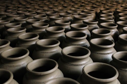 Free An image showcasing handcrafted clay pots arranged in a striking repetitive pattern. Stock Photo