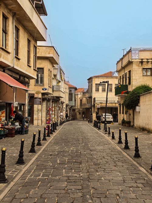 Free Cobblestone street in Gaziantep, Türkiye lined with shops and historic architecture. Stock Photo