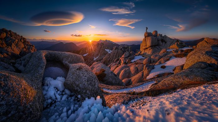 Lenticular clouds over a sunlit summit at sunset — photo by Alejandro De Roa on Pexels