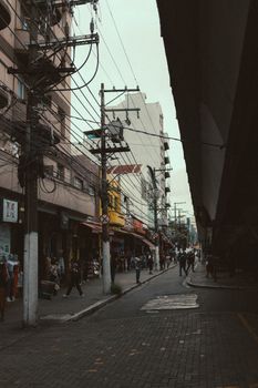Urban street view featuring busy sidewalks, architectural buildings, and visible utility poles.