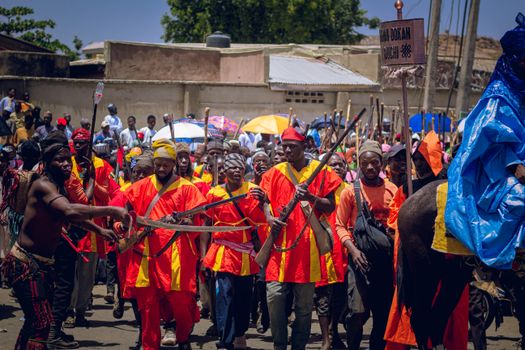 Vibrant cultural parade showcasing traditional costumes and instruments, capturing a lively outdoor festival.