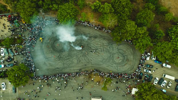 Aerial shot capturing a crowded car drifting event in Abuja, Nigeria.