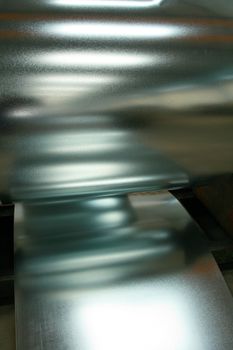 Close-up of blurred reflections on a shiny metallic surface with an industrial feel.