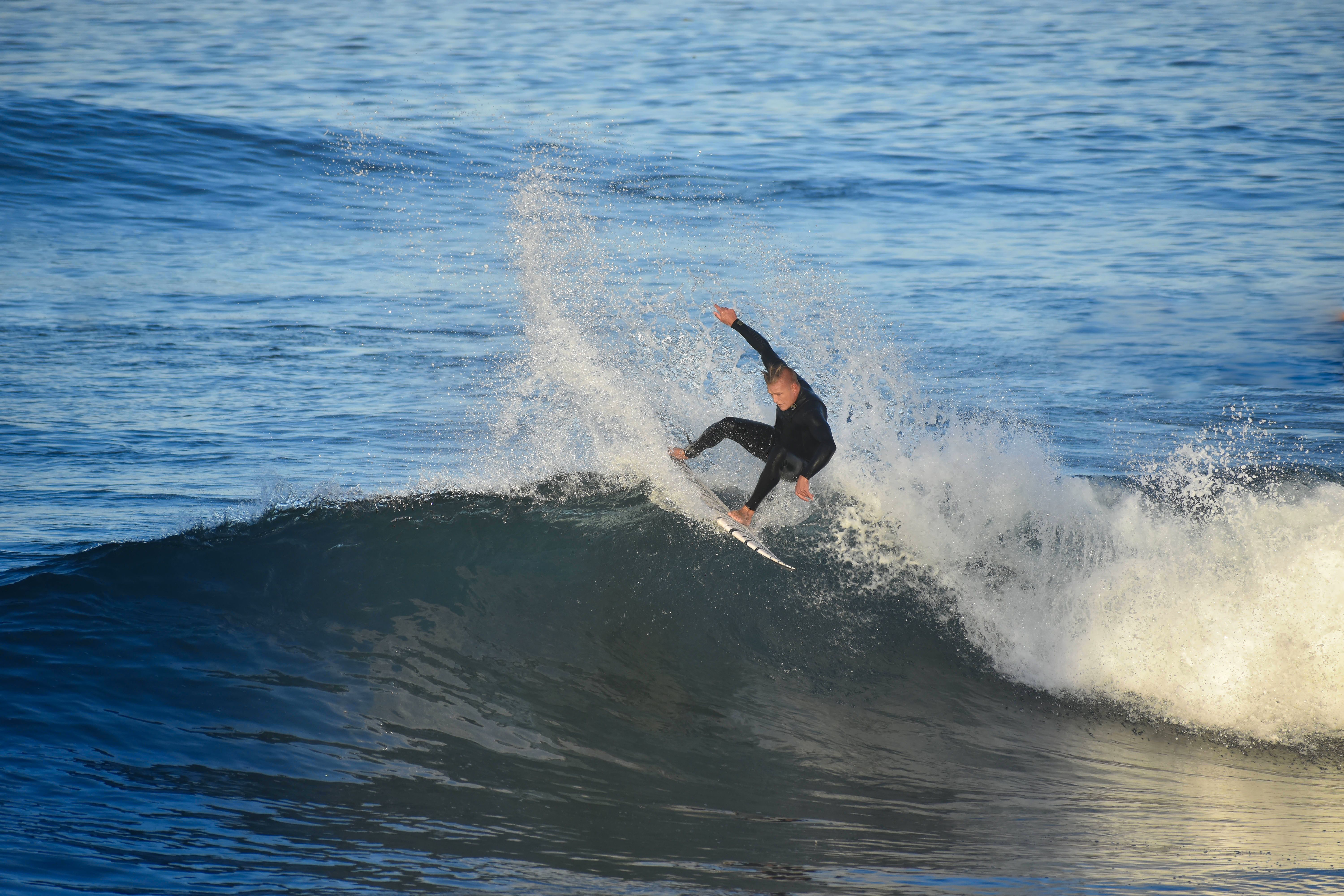 Dynamic Surfing Action on Ocean Wave · Free Stock Photo