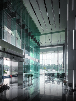 Spacious corporate building lobby featuring glass walls and contemporary design elements.
