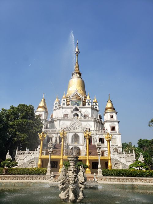 Free Scenic view of Buu Long Pagoda with its golden spires and serene fountain in Ho Chi Minh City, Vietnam. Stock Photo
