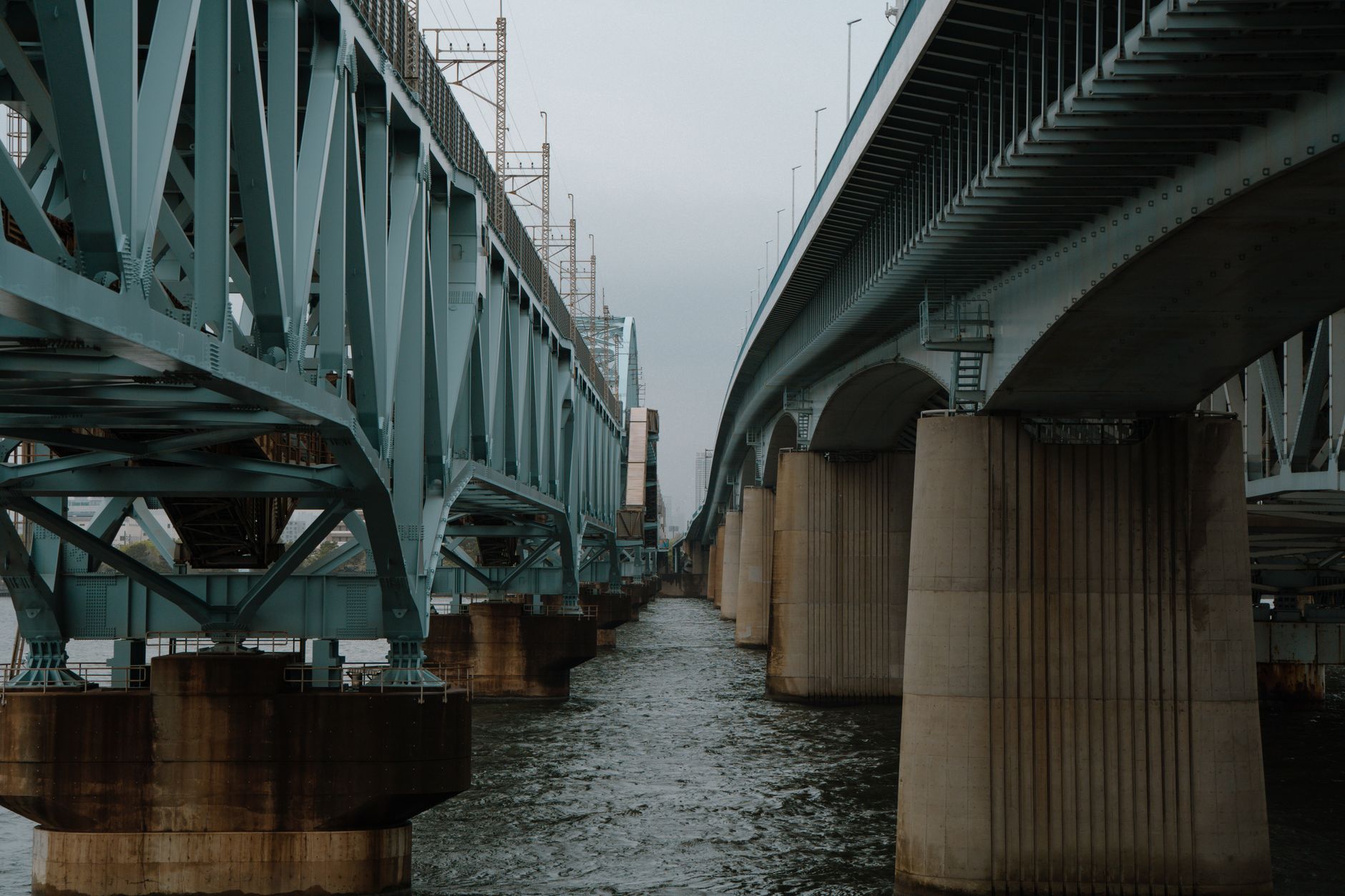 A steel bridge spans a waterway in Tokyo, showcasing modern architectural engineering. — free online jigsaw puzzle on JigsawPuzzlesFreeOnline.org