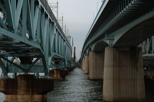 A steel bridge spans a waterway in Tokyo, showcasing modern architectural engineering., free online jigsaw puzzle on JigsawPuzzlesFreeOnline.org