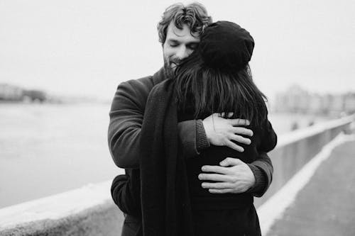 Free Man and Woman Hugging on Bay View Stock Photo