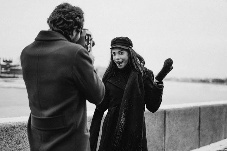 Grayscale Photo Of Man And Woman In Black Coat