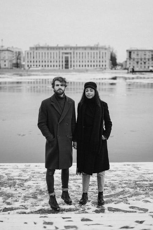 Monochrome Photo of Couple Standing While Holding Hands