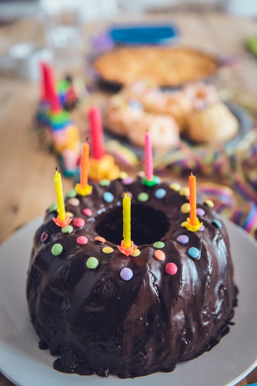 Close-up Photo of Chocolate Cake with Colorful Candles