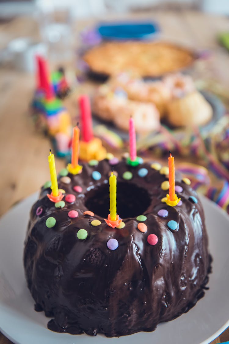 Close-up Photo Of Chocolate Cake With Colorful Candles