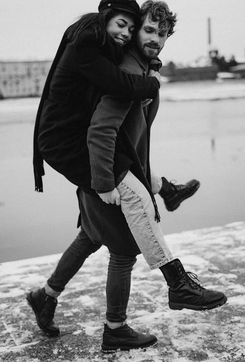 Man Walking While Carrying His Woman