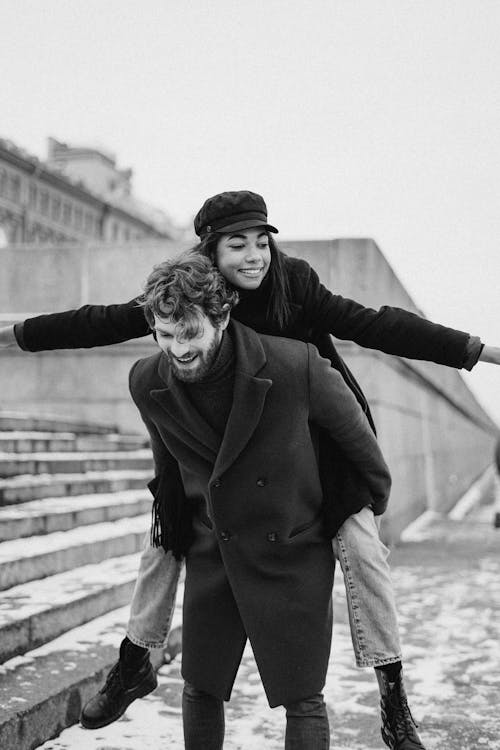 Monochrome Photo of Man Carrying His Woman