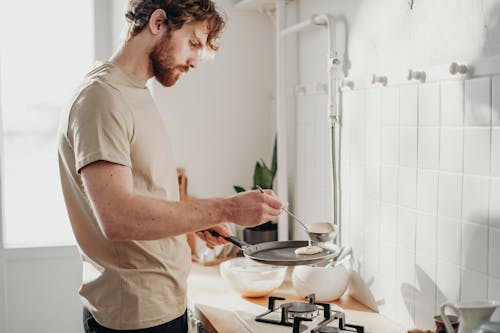 Free Man Cooking Pancakes  Stock Photo