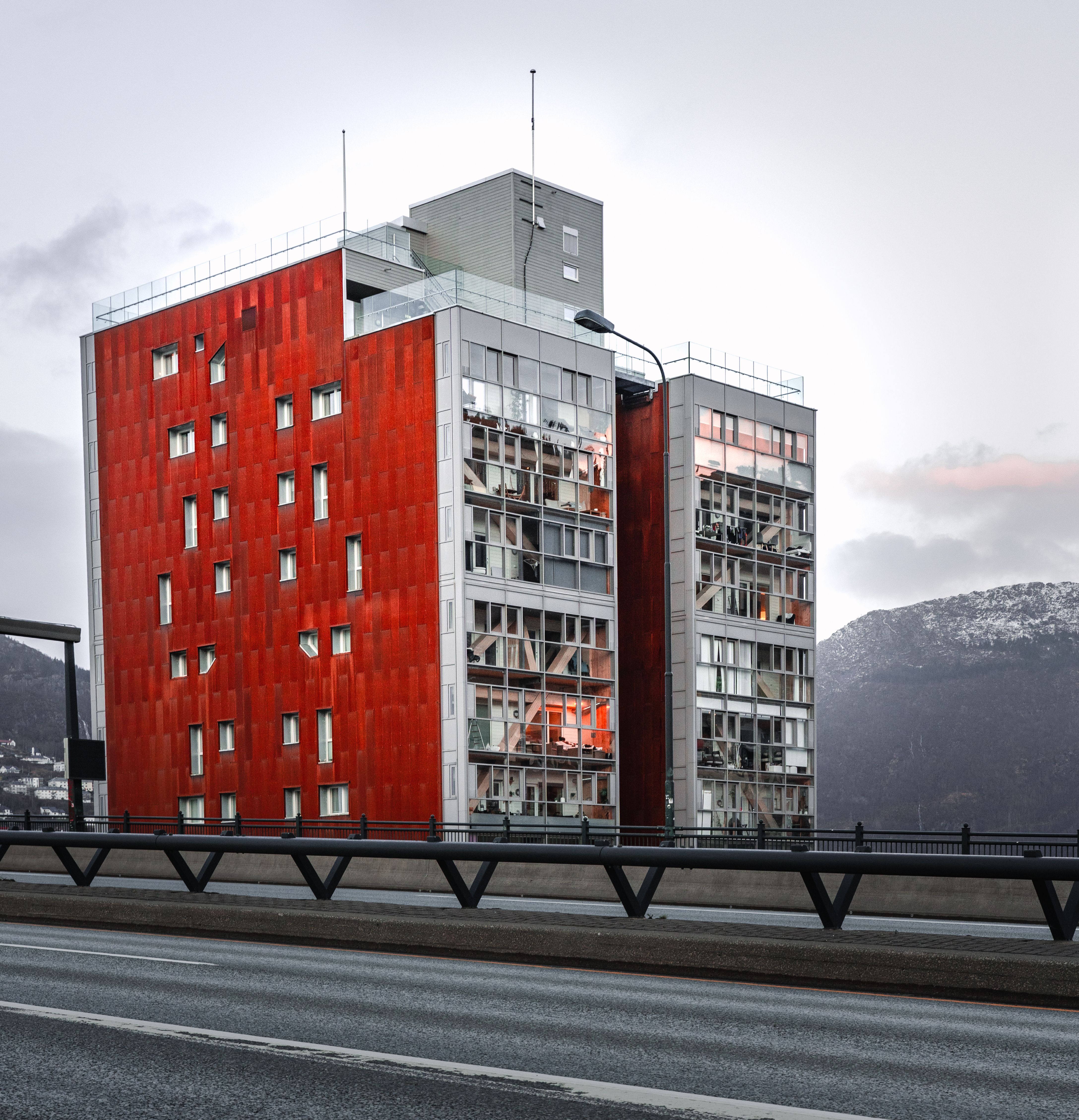 Modern Red Building by a Mountain Roadside · Free Stock Photo