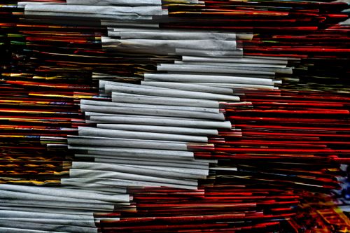 Free Stack of vibrant colored papers with a unique abstract arrangement photographed closely. Stock Photo
