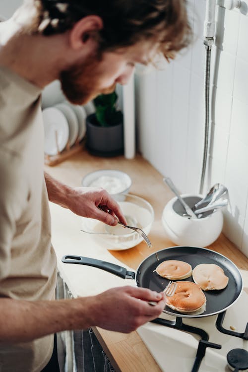 Free Man Cooking Breakfast Holding Fork Stock Photo