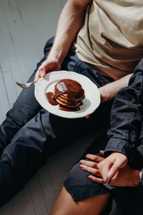 Free High-angle view of pancakes drizzled with chocolate syrup, a perfect morning indulgence. Stock Photo