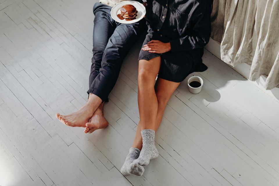A couple enjoying a quiet breakfast with pancakes and coffee