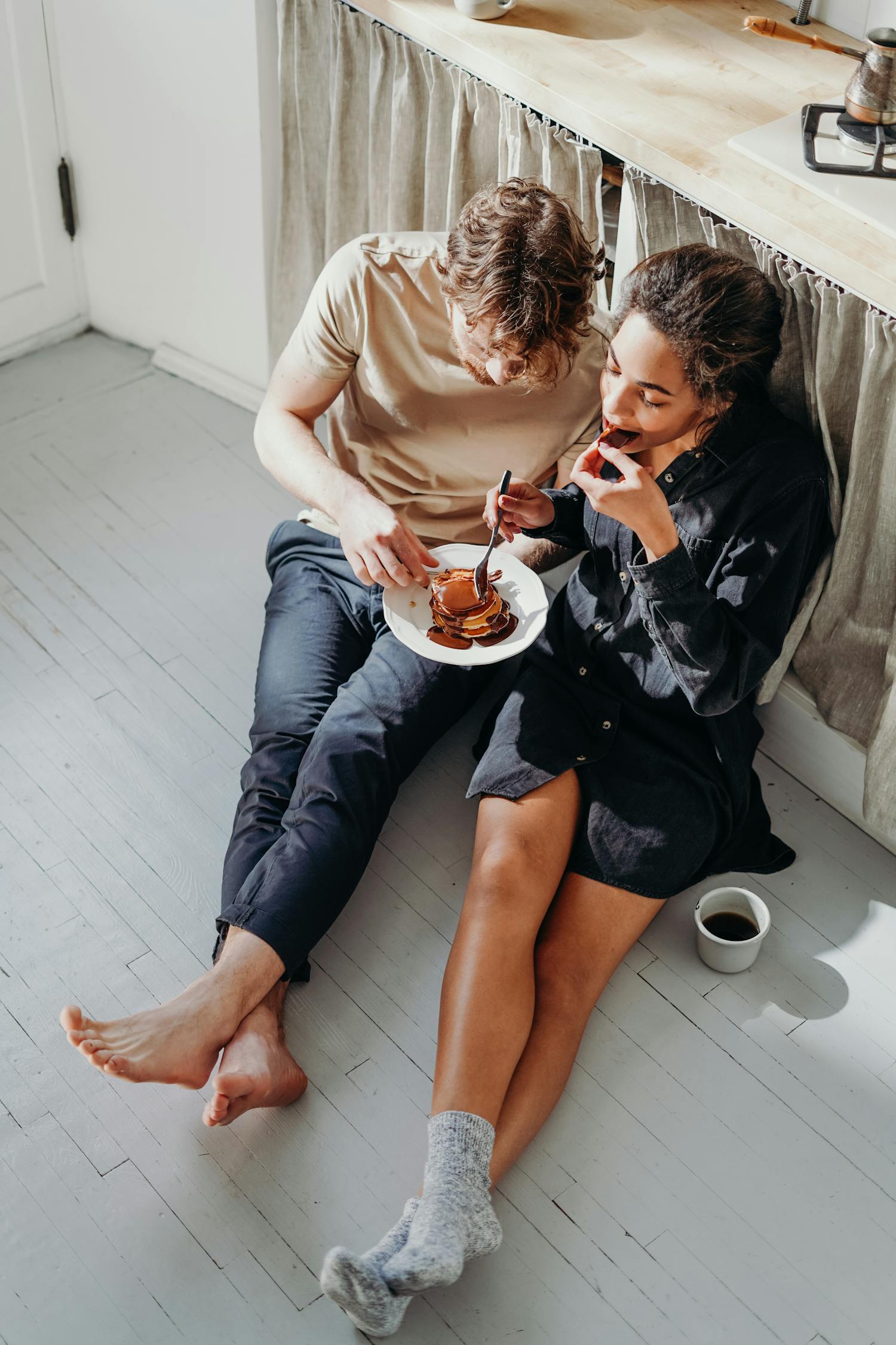 Two Person Eating Pancake on White Wooden Floor