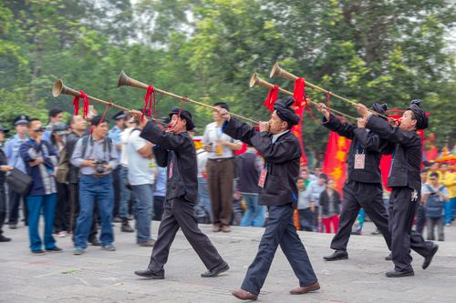 Free Musicians showcase traditional instruments in a cultural parade in Guangxi, China, highlighting regional customs. Stock Photo