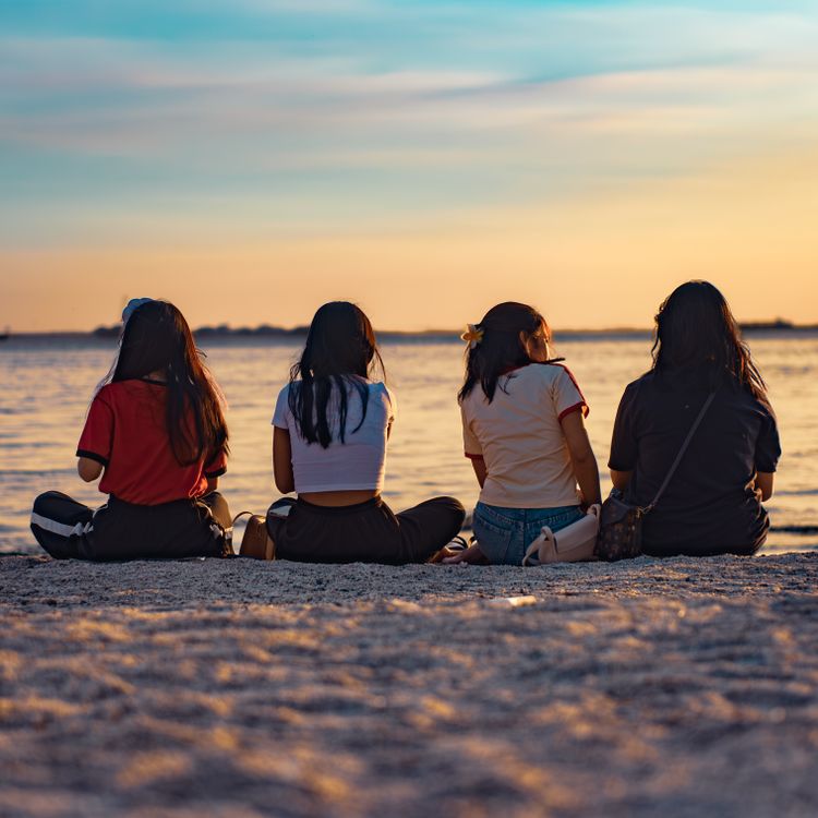 Friends Enjoying a Beach Sunset View · Free Stock Photo