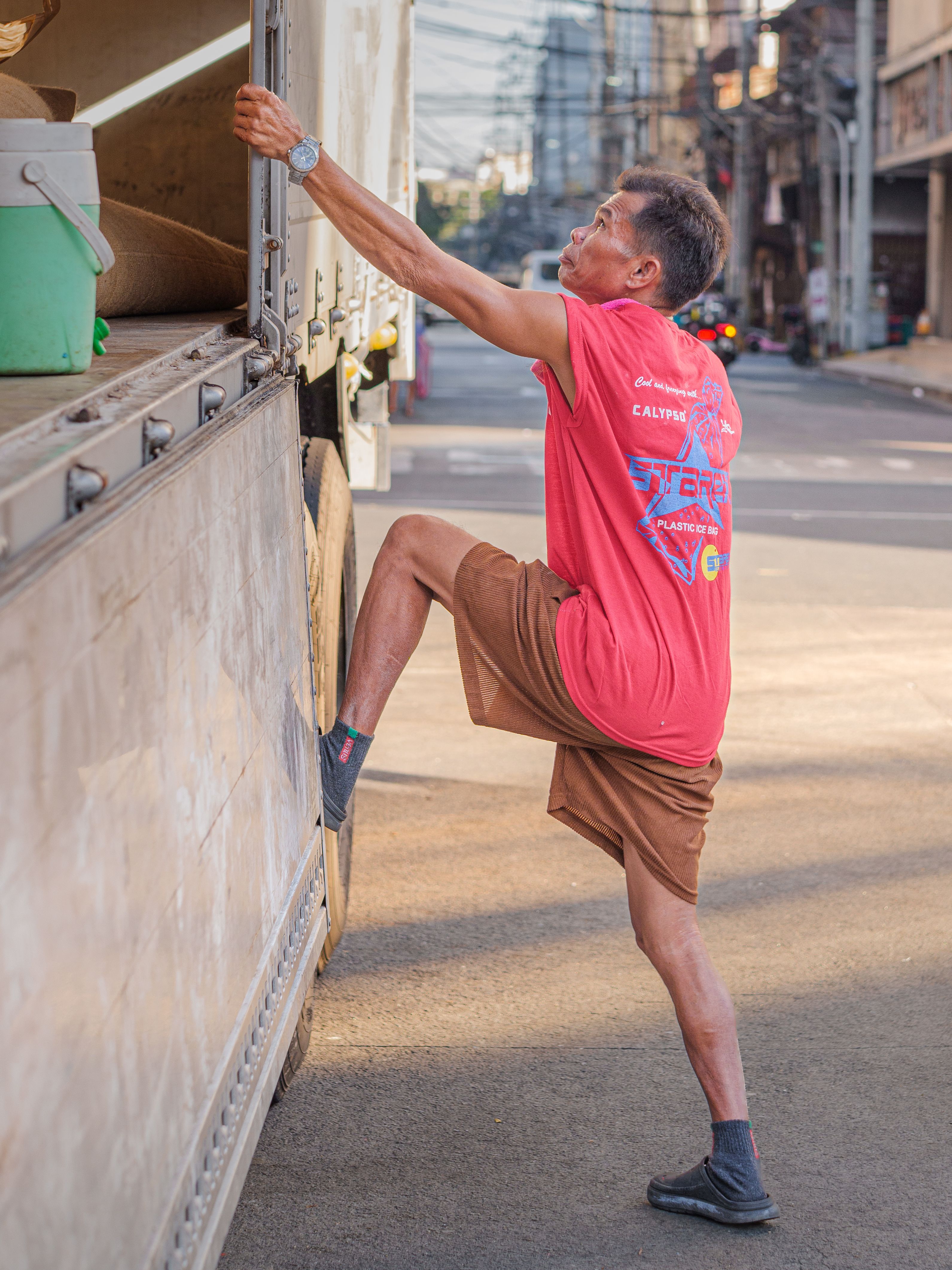 Man Loading Truck in Manila Street · Free Stock Photo