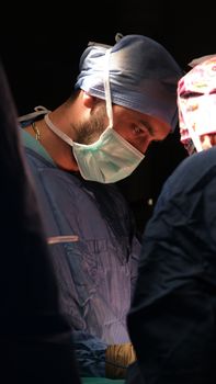 Surgeons in action during a critical surgical procedure, showcasing teamwork and expertise.