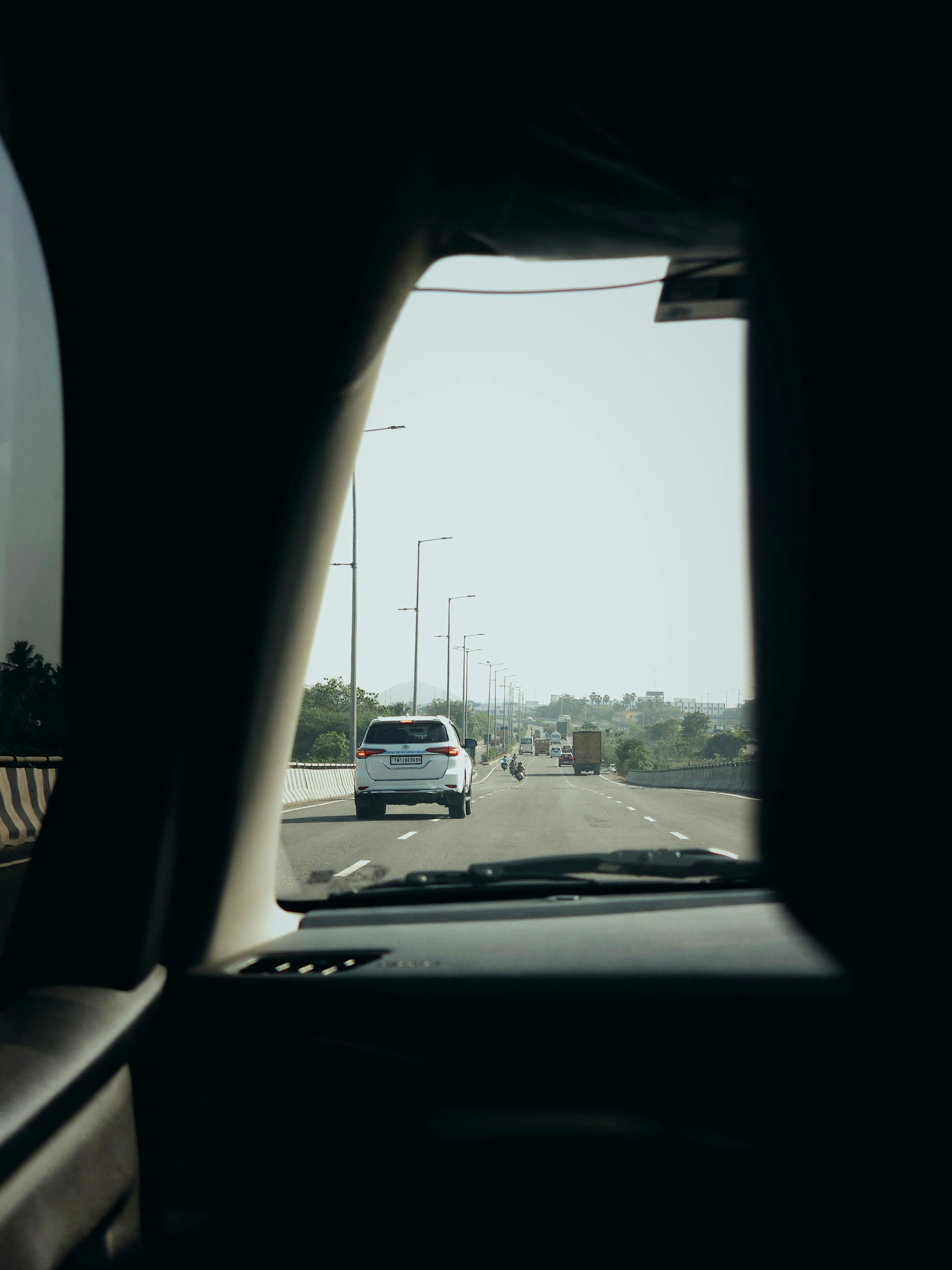A view of the highway from inside a car, capturing a sunny day drive.