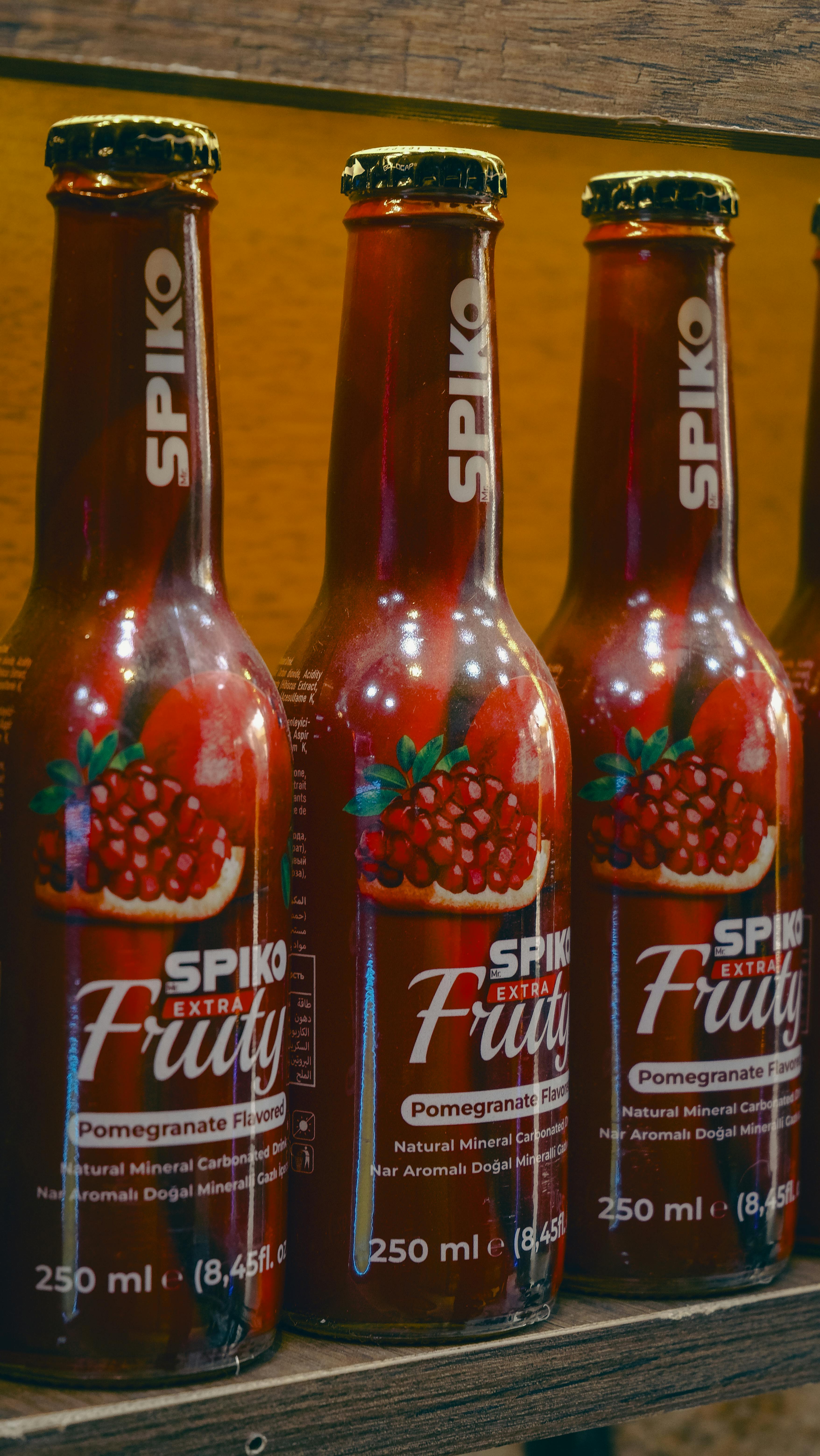Close-up of Spiko Fruity pomegranate flavored mineral soda bottles in a Gaziantep market