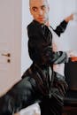 一位男舞者身着黑色服装，在室内环境中捕捉到了中间动作