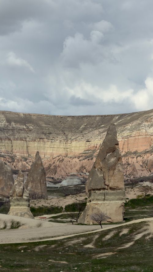 Free Beautiful rock formations under a cloudy sky in Cappadocia, Türkiye. Stock Photo