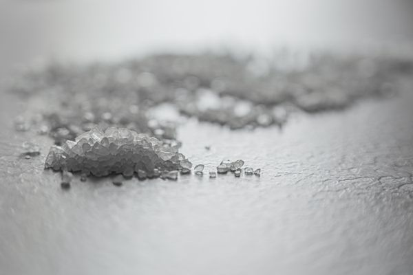 Coarse rock salt scattered across a textured surface — photo by Castorly Stock on Pexels