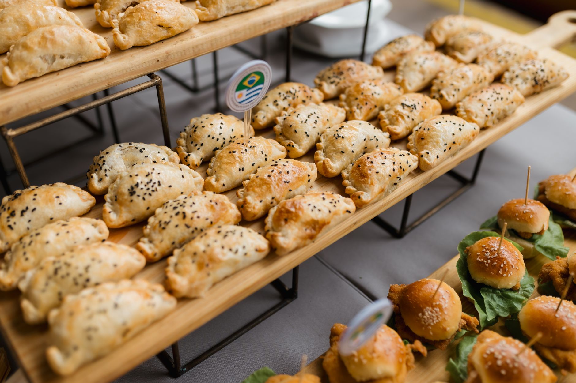 Assorted savory pastries and sliders elegantly displayed, perfect for catering or events.