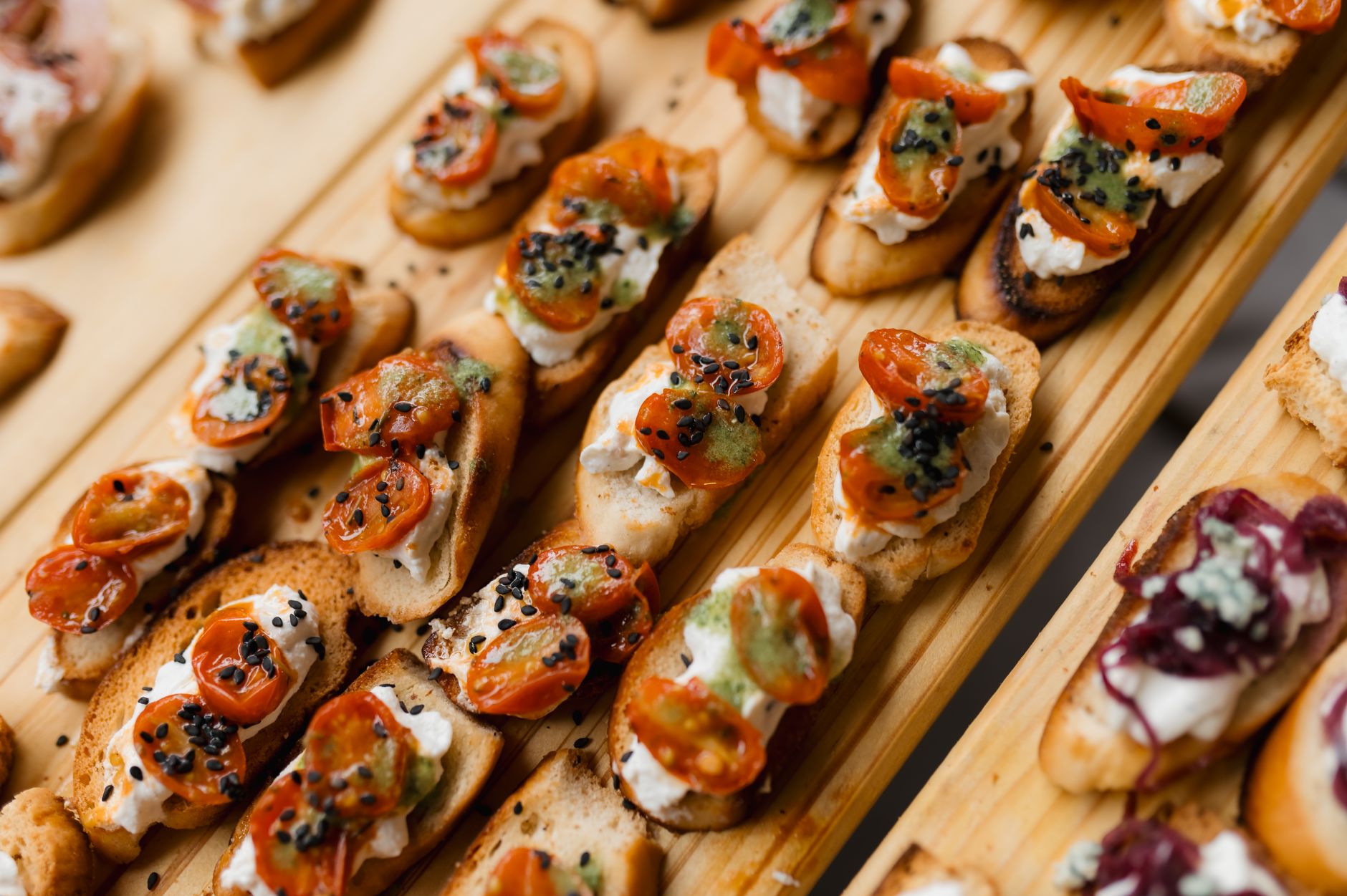 An appetizing display of gourmet bruschetta topped with cherry tomatoes and cheese, perfect for a party or event.