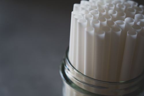 Free Elegant close-up of eco-friendly white drinking straws in a glass jar, perfect for sustainable themes. Stock Photo