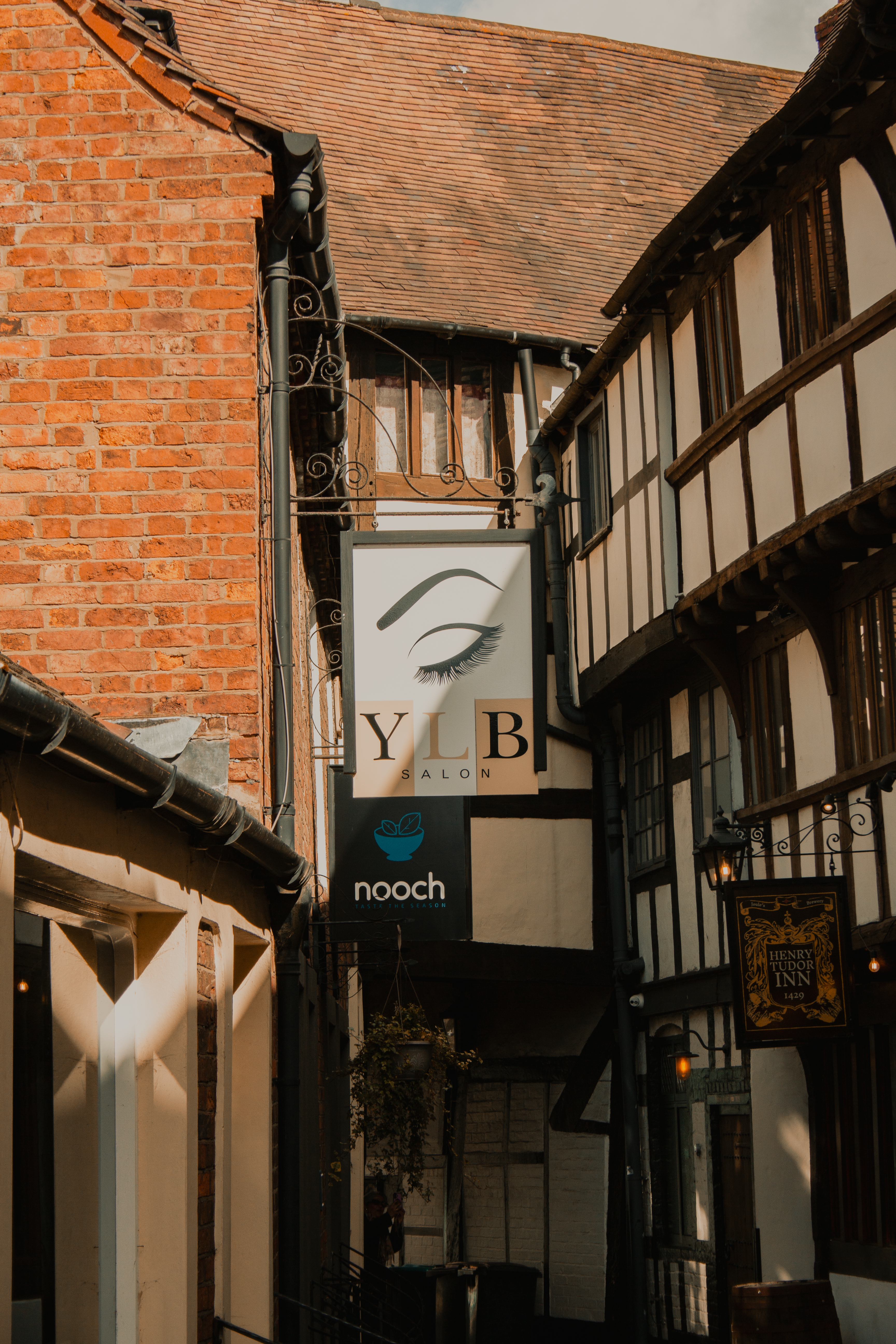 Charming view of Tudor buildings and a shop sign in Shrewsbury, England.