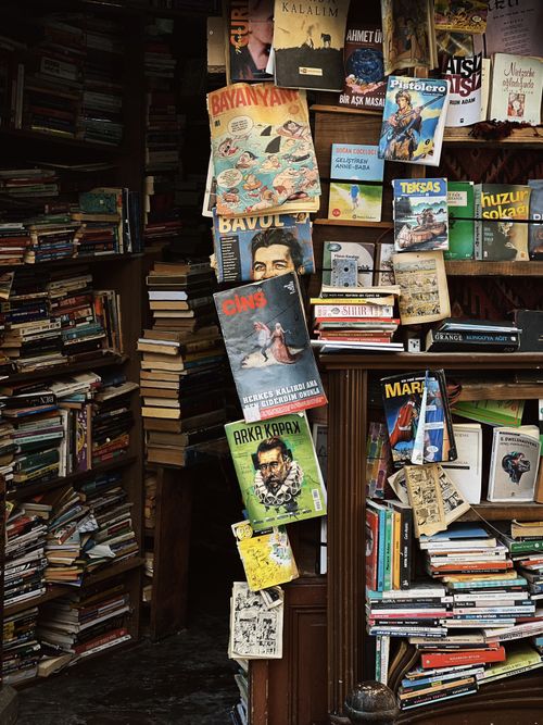 Free Explore a cozy vintage bookshop filled with diverse books and magazines in an artistic setting. Stock Photo